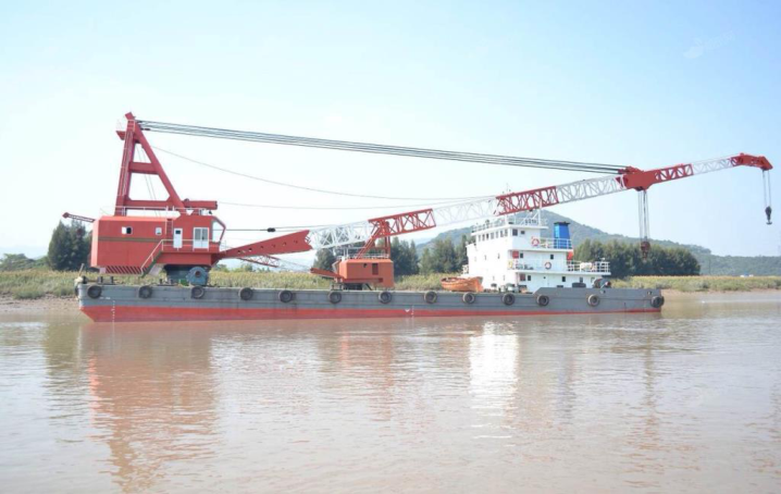 WAN-CRANE-002 self-propelled revolving floating crane with dual booms on grey and red barge