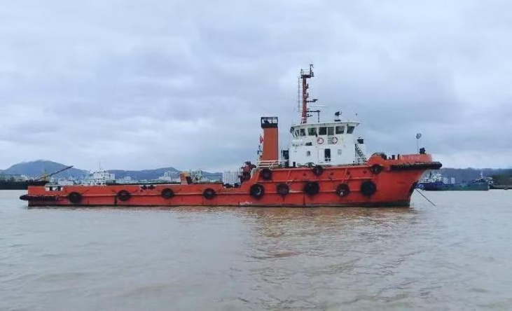 WAN-TUG-002 orange tugboat with heavy fender arrangement and red flag at stern