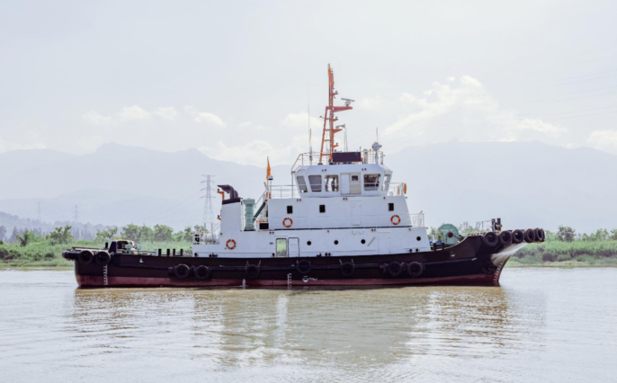 WAN-TUG-004 tugboat on river with mountainous backdrop